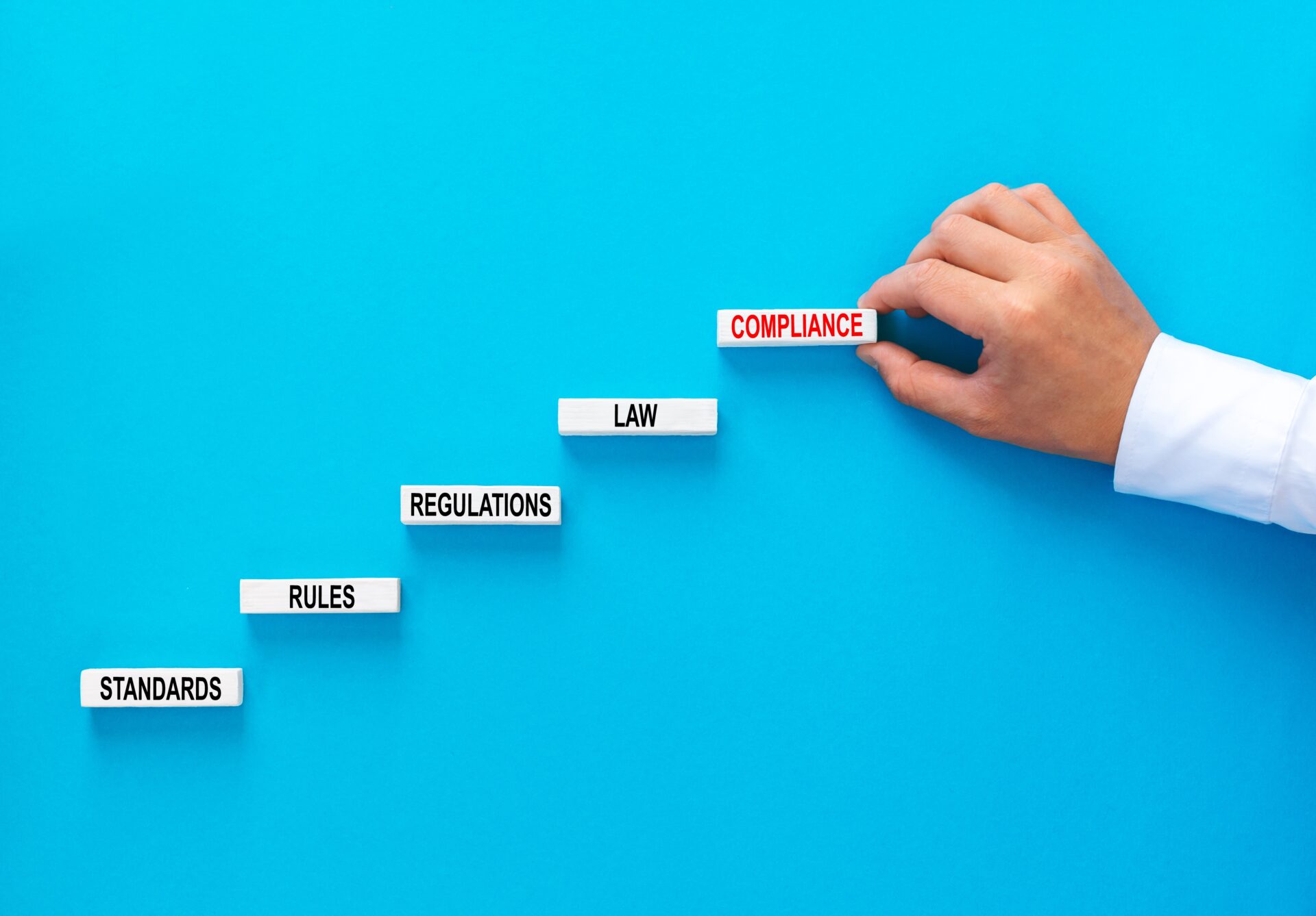 businessman-hand-building-wooden-blocks-with-compl-2022-11-16-17-03-27-utc