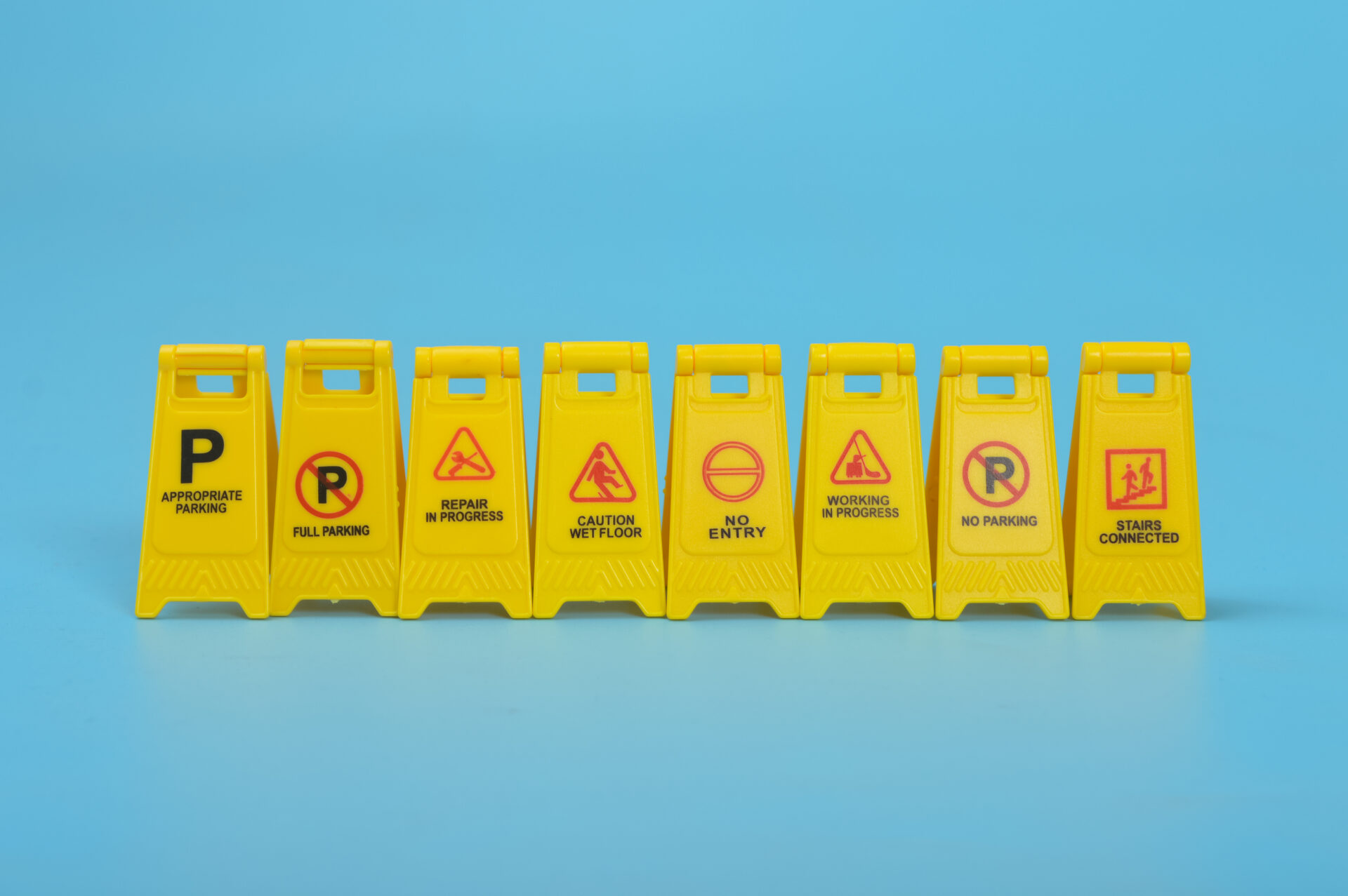 Danger and caution street signs isolated on a blue background.