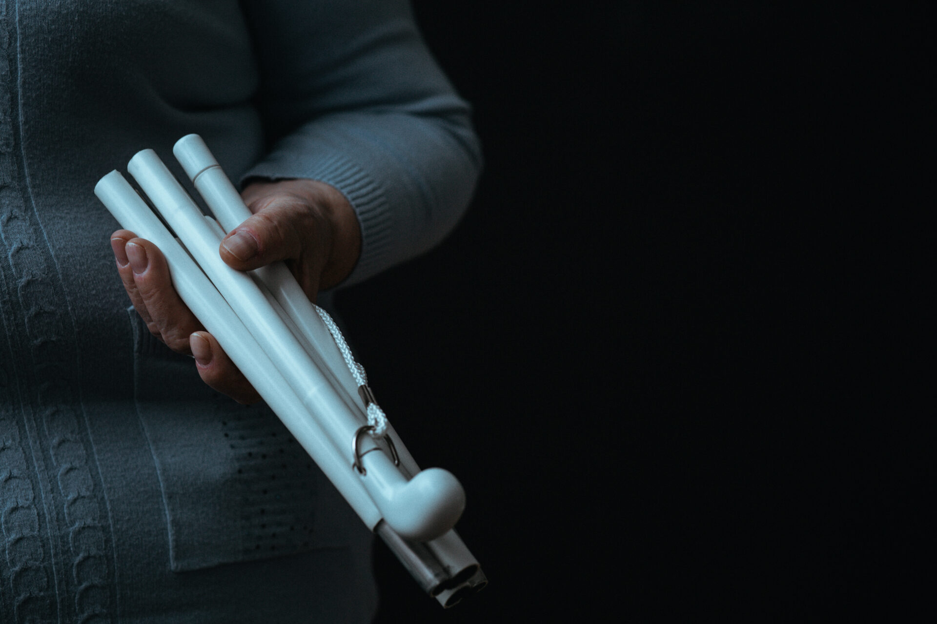 Close up of blind person's white walking stick.