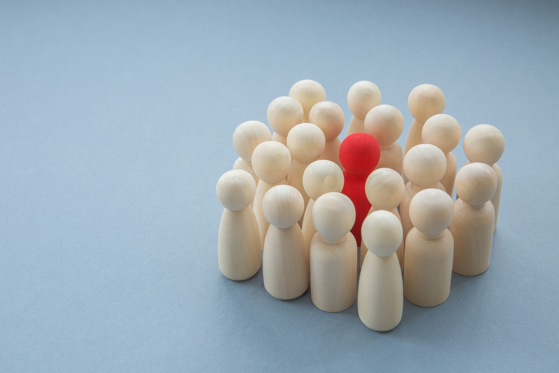 A single red person surrounded by others representing infectious disease.